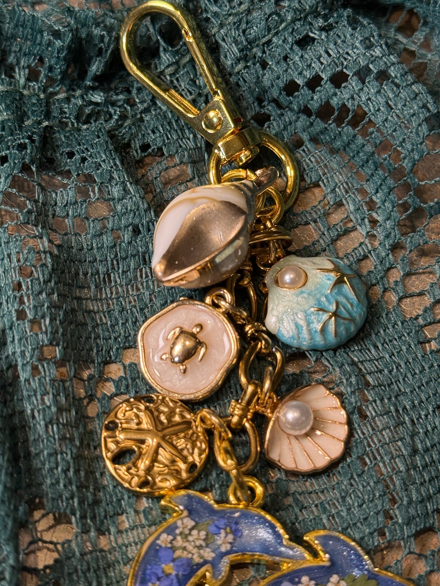 Gold dolphin bag charm