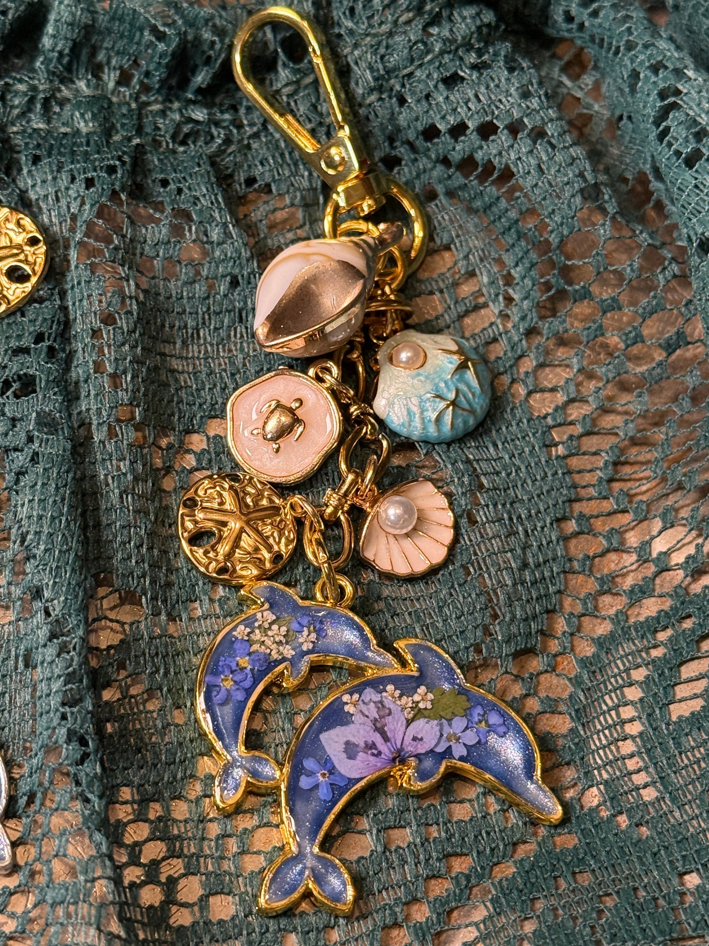 Gold dolphin bag charm