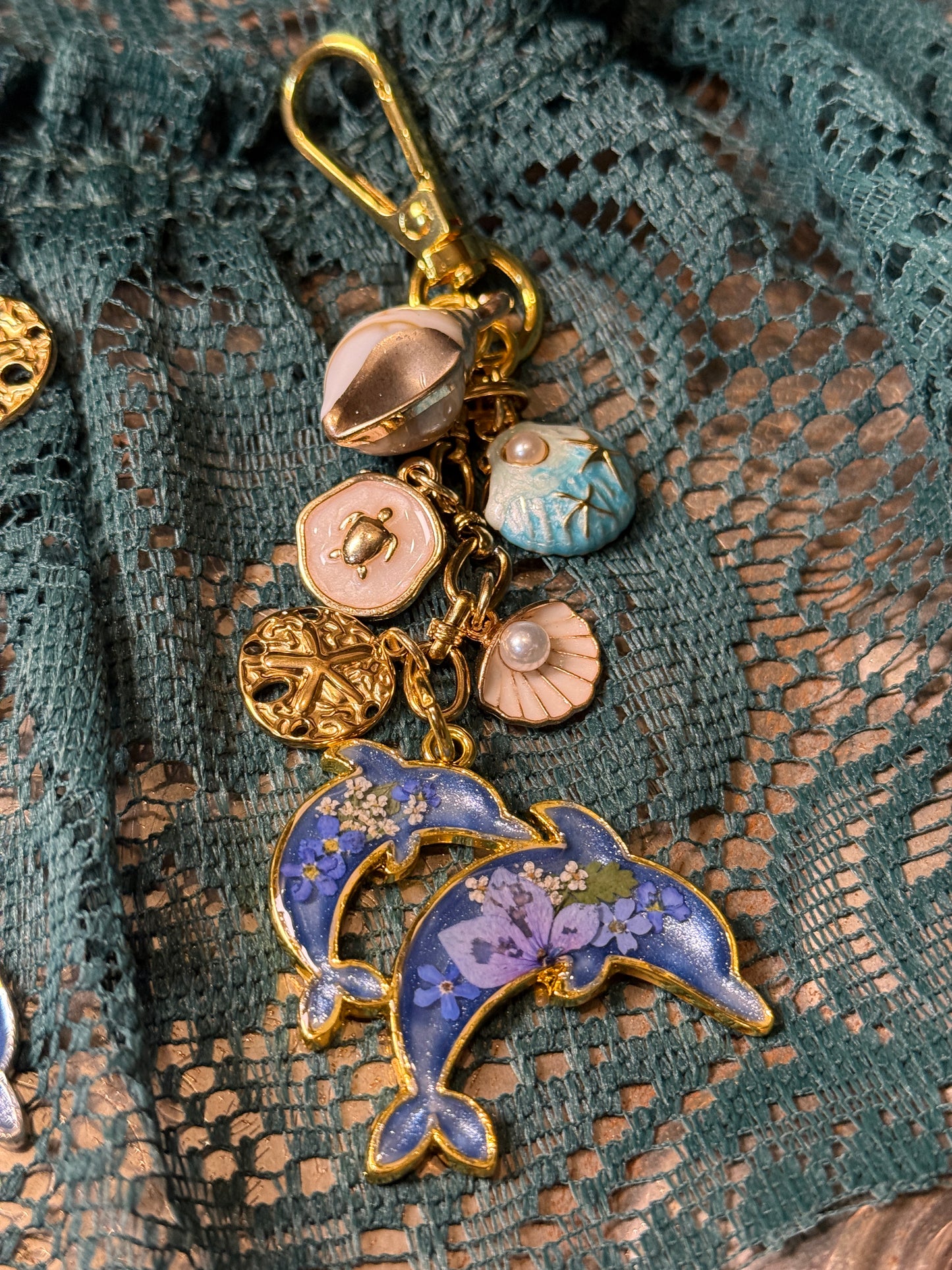 Gold dolphin bag charm